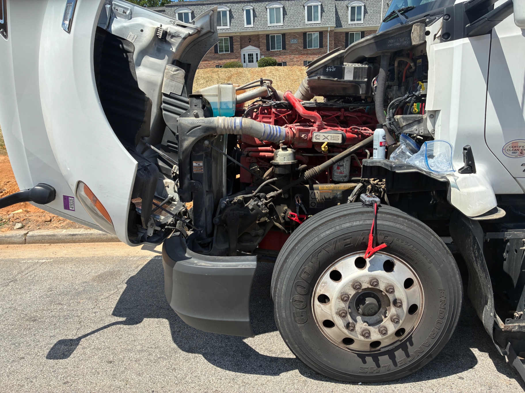 Semi truck with hood up receiving battery jumpstart service in Atlanta